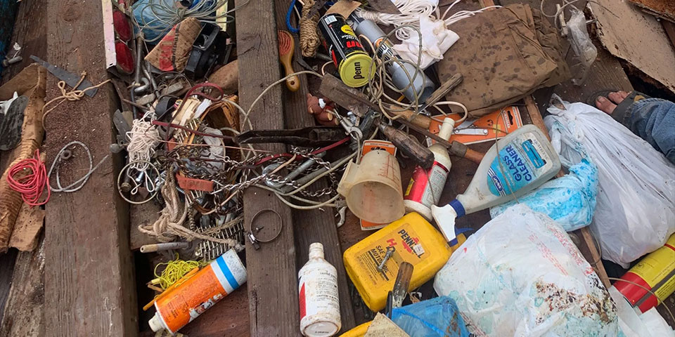 Dumpster bin loaded with junk to be picked up Oahu Dump Run