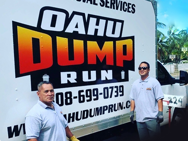 Oahu Dump Run employees at the back of the truck